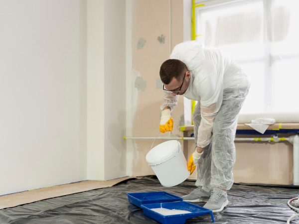full-shot-man-pouring-paint_23-2149344028